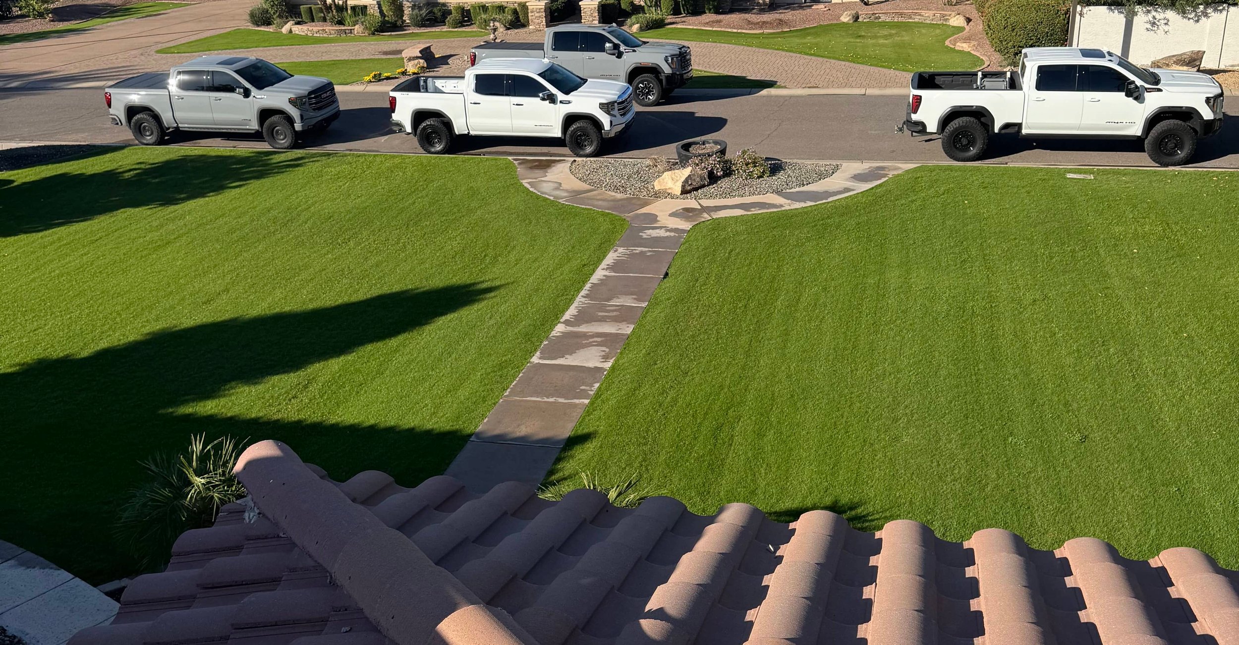 Aerial view of Arizona residential neighborhood with varied roof styles and mountain backdrop