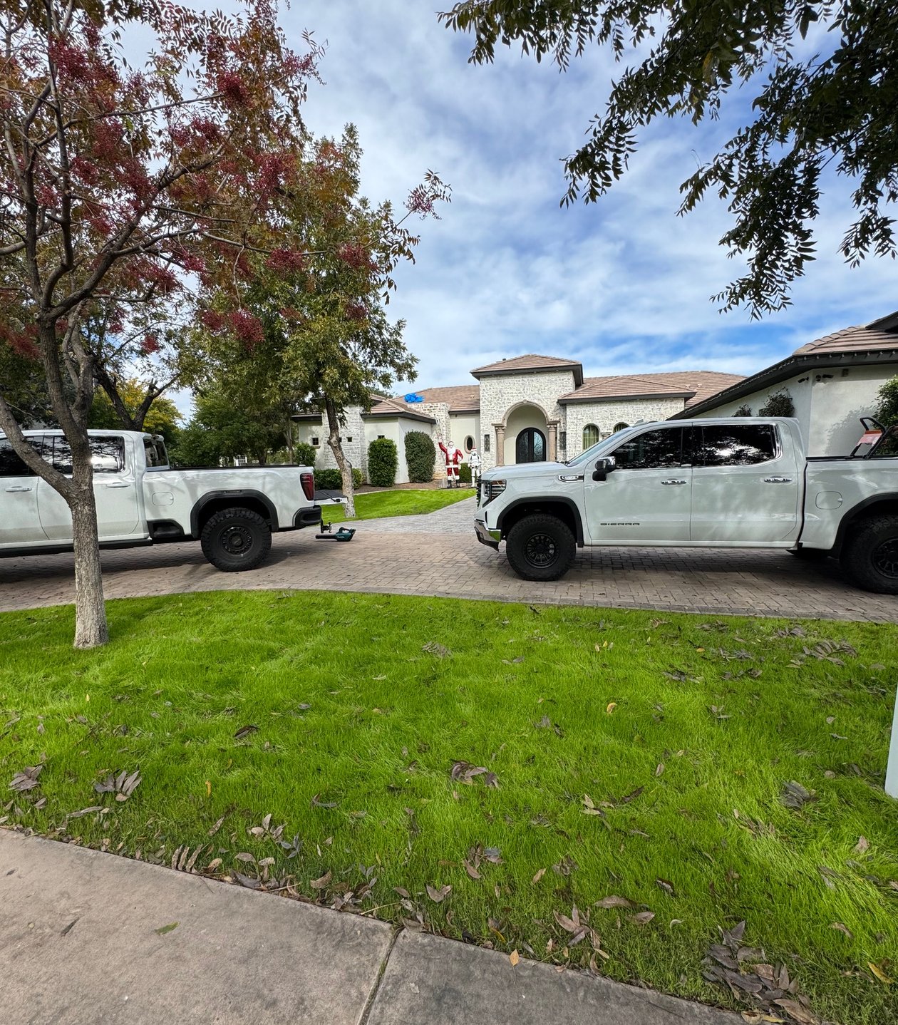 Roofing contractors installing dark shingles on residential roof
